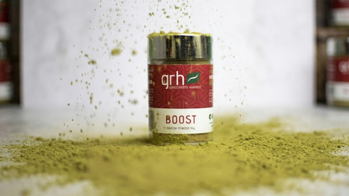 GRH Kratom leaf powder and capsules on a clean surface with batch labeling